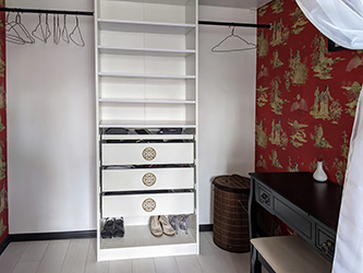 Open wardrobe/boudoir area with hacked Ikea system fit into the wall space and decorated with bronze prosperity symbols ordered from China.